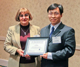 Anna Karecki, Simon’s mother, presents the 2011 Simon Karecki Award to Wen Zhang.