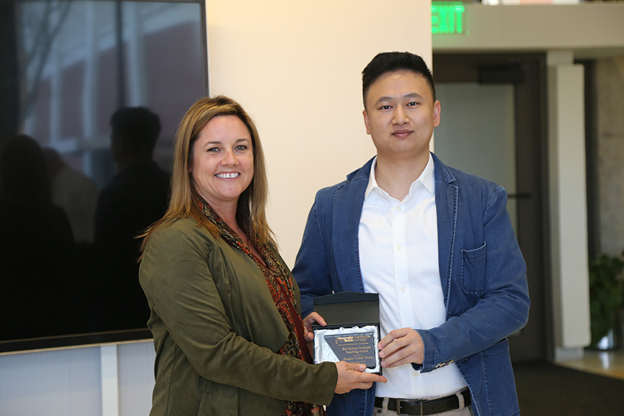 Frankie Ouyang receives his award from Interim School Chair Kimberly Kurtis. (Photo: Jess Hunt-Ralston)