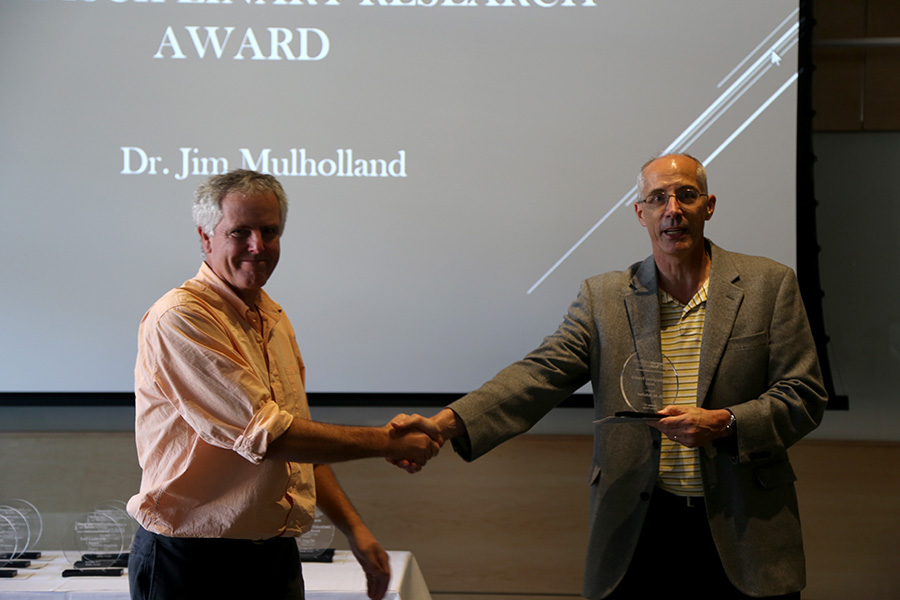 Jim Mulholland receives his award from Ted Russell