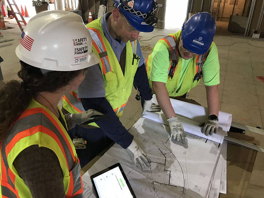 Rachel Brashear, left, discusses plans for the Interdisciplinary Design Commons with part of the construction team. She has been working for Gilbane Building Company, filling the role of the on-site project engineer for the last year and a half while she finishes her bachelor's degree in civil engineering. (Photo Courtesy: Rachel Brashear)