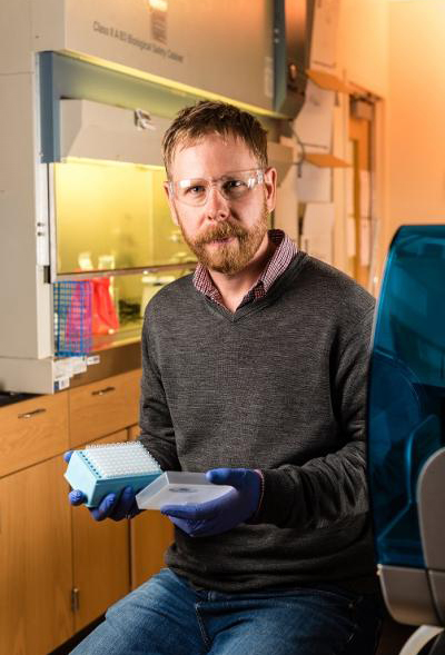 Assistant Professor Joe Brown in his environmental health microbiology lab. (Photo: Gary Meek)