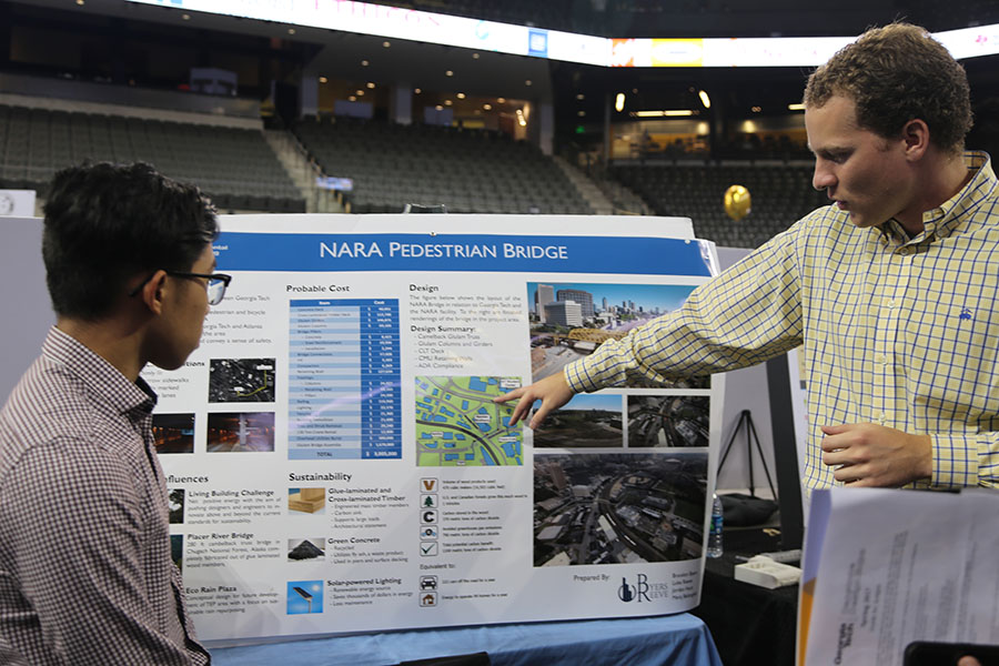 Merq Belongilot and Jordan Hunt from team Byers-Reeve, LLC, talk about their senior design project at the Capstone Design Expo. (Photo: Jess Hunt-Ralston)