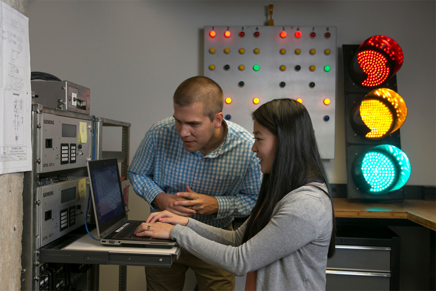 Sean Coleman, a traffic operations and intelligent transportation systems engineer at Kimley-Horn and Associates, works with his colleague Bing Zhang to test traffic signal equipment and signal timing databases in the Kimley-Horn Advanced Signal Timing Lab. (Photo Courtesy: Kimley-Horn and Associates)