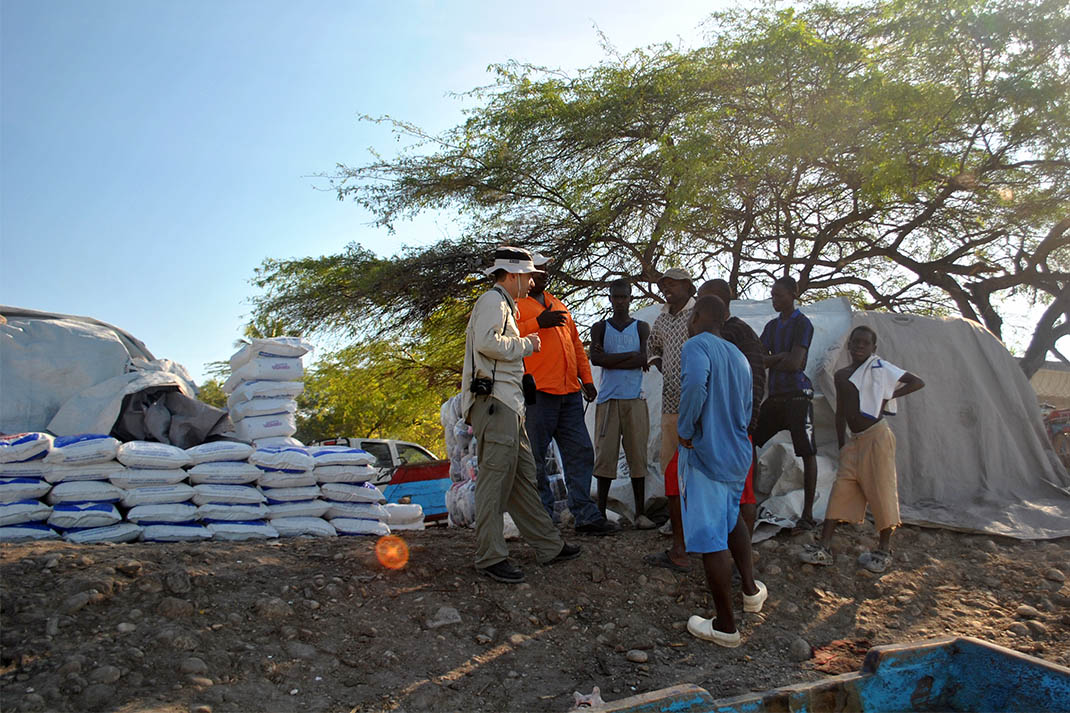 Hermann Fritz, right, talks with people in Haiti on one of his research trips after an earthquake wreaked havoc on the island nation in 2010. Fritz told public radio's Marketplace the temporary communities that have since sprung up on the country's hillsides are now at risk from flooding and landslides in the wake of Hurricane Matthew. (Photo Courtesy: Hermann Fritz)