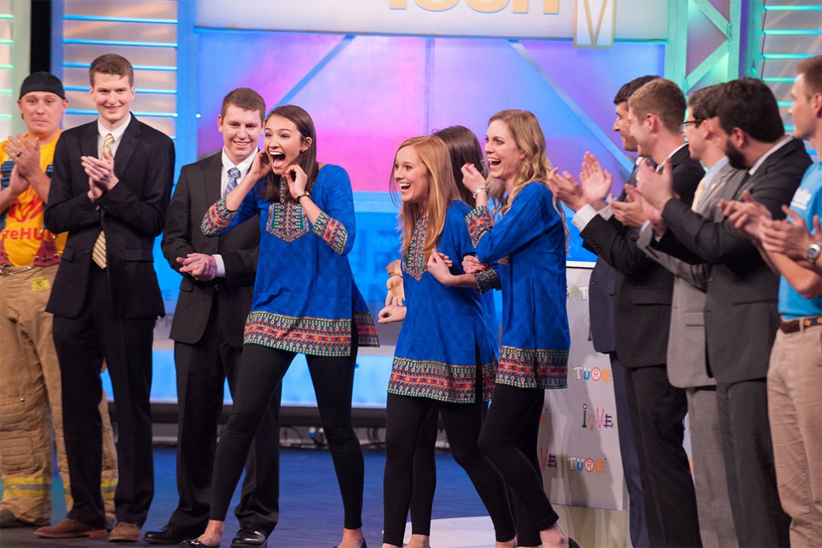 Team TruePani reacts after they're announced as the People's Choice Award winners at the 2016 InVenture Prize finals. The team, center in blue, included business administration majors Sarah Lynn Bowen, left, and Naomi Ergun, obscured, as well as environmental engineering major Shannon Evanchec and civil engineering major Samantha Becker, right. The team designed an antimicrobial cup and water storage device that makes drinking water safer. Evanchec and Becker have been working full-time for the last year to turn their winning invention into a viable business. (Photo: Fitrah Hamid)