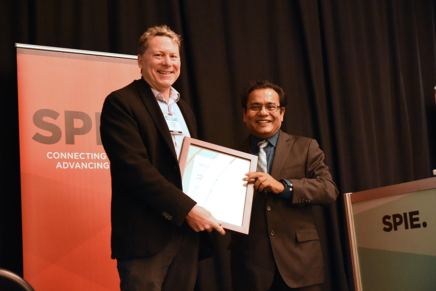 Professor and Associate Dean Laurence Jacobs, left, accepts a lifetime achievement award in nondestructive evaluation from Tribikram Kundu at the SPIE Smart Structures and Nondestructive Evaluation Symposium in early March. (Photo Courtesy: Laurence Jacobs and SPIE)