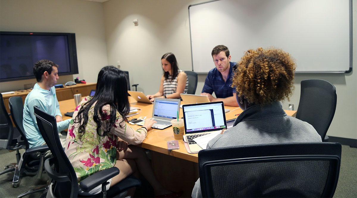 Ph.D. student Chloe Johansen, third from left, brainstorms with her group members on an October morning. Their group is part of the Scheller College of Business' Technological Innovation: Generating Economic Results program (TI:GER). Johansen is working with two business students and two Emory University law students to commercialize her Ph.D. research. (Photo: Joshua Stewart)