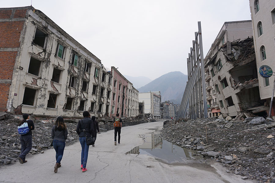 Students from the International Disaster Reconnaissance Studies course walk through ruined buildings in Old Beichuan, China. The city has been left as a memorial to those killed when it was rocked by the 2008 Wenchuan earthquake in central China. The site was one of the places students visited in China and Japan over Spring Break as they considered the impact of disasters and how communities rebuilt. (Photo Courtesy: Lynnae Luettich and Katie Popp)