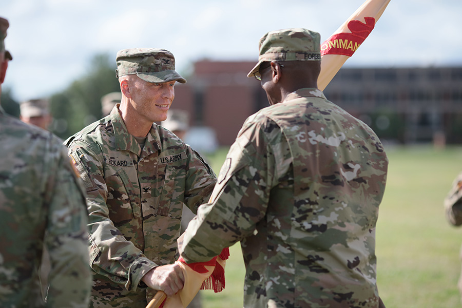 Col. Tom Rickard, BSCE 1990, assumed command of the U.S. Army’s Fort George G. Meade August 4. During the change of command ceremony, Rickard passes the garrison colors to Command Sergeant Major Rodwell L. Forbes. The passing of the colors to the command sergeant major symbolizes Rickard’s first official act and represents his trust in the unit’s noncommissioned officers corps. (Photo: Fort George G. Meade Public Affairs)