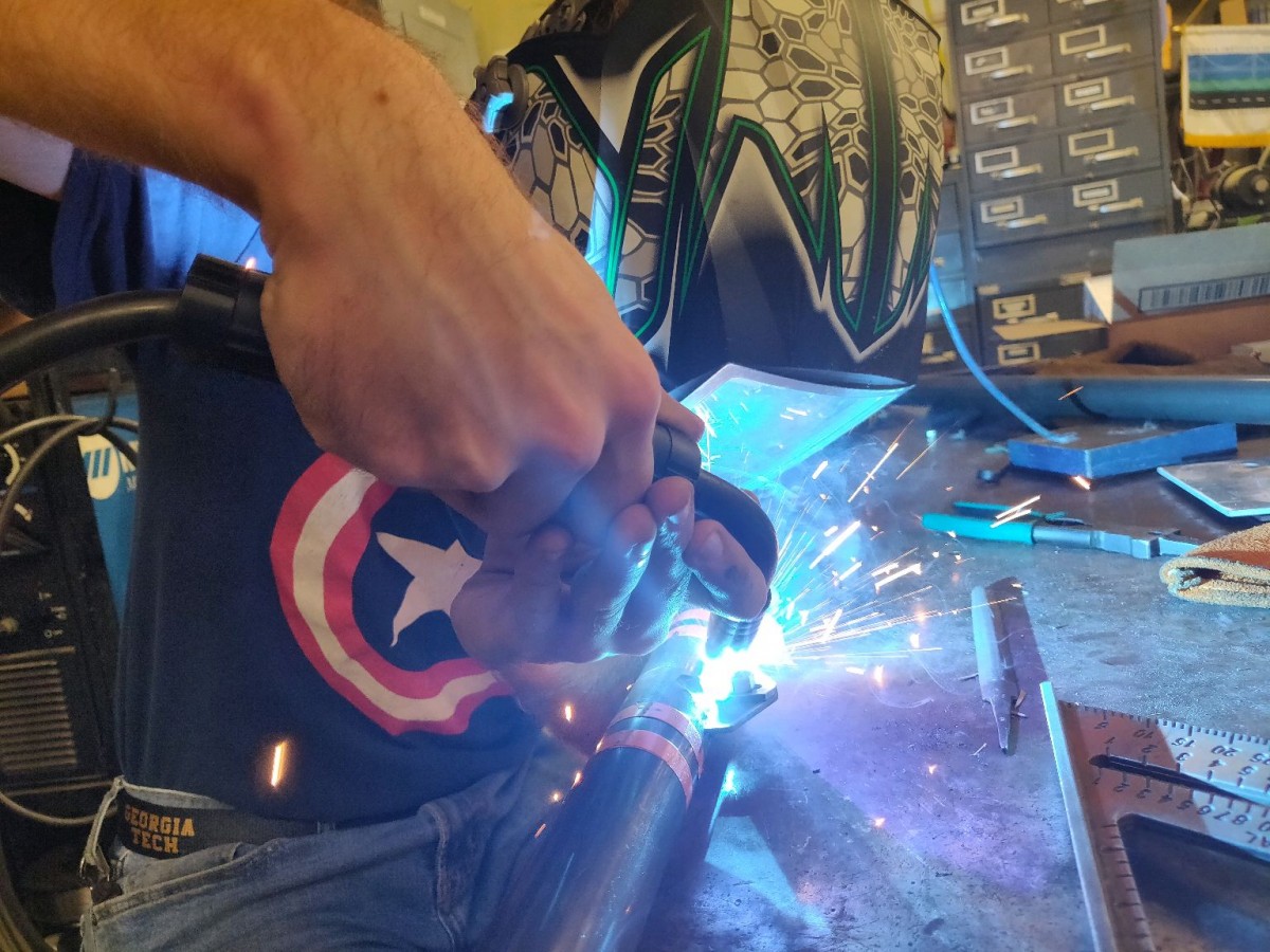 A member of the GT AISC team fabricating the steel bridge