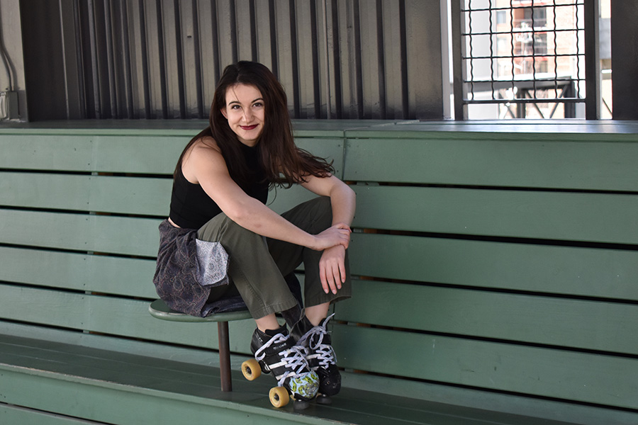 Guiliana Stovall sits on a bench with her roller derby roller skates. Stovall, a long-time roller derby player, knew she would continue to skate when she came to Georgia Tech. And since Tech had no outlet, she founded Yellow Jacket Roller Derby. (Photo Courtesy: Giuliana Stovall)