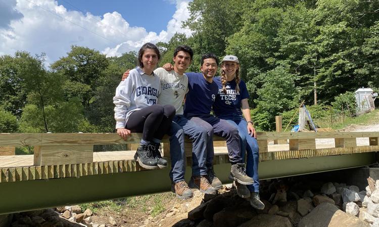 Students sitting on a newly built bridge