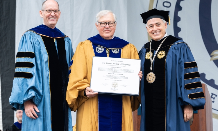 Mike Messner receives an honorary doctorate from Georgia Tech, flanked by Provost Steve McLaughlin and President Ángel Cabrera.