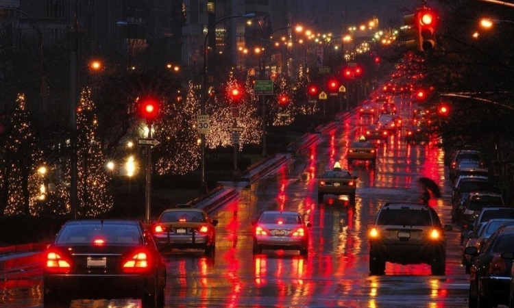 Cars driving on a wet road at night 