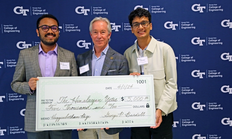 Photo of team Himalayan Yetis with donor Bill Higginbotham holding a big check.