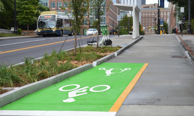A green cycle track next to a street