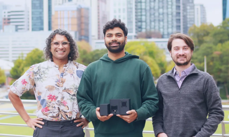Three researchers pose with their technology 