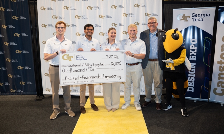 CivCore Consulting pose with their big check next to school chair Don Webster and Buzz at the Capstone Design Expo