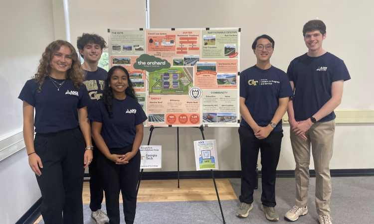 Group of five Georgia Tech students standing in front of an easel with their project displayed