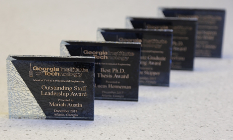 A row of awards plaques presented to students, faculty and staff at the 2017 CEE Awards Ceremony Dec. 11. (Photo: Jess Hunt-Ralston)