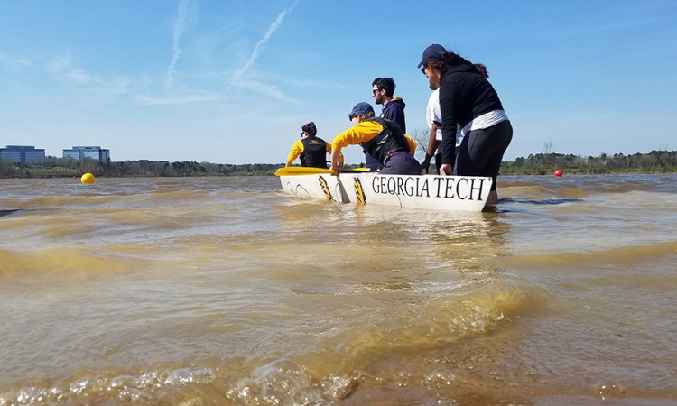 The ASCE concrete canoe team launches their vessel for the women’s sprint race, where chapter president Caroline Stanton and conference chair Alesa Stallman placed second after winning their heat. (Photo: Vy Le)