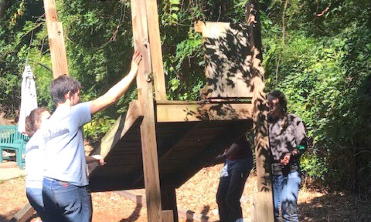 Students from the Georgia Tech chapter of the American Society of Civil Engineers take down a piece of playground equipment for International Women's House in Decatur, Georgia. (Photo Courtesy: ASCE Georgia Tech)