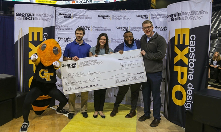 The BAMM Engineering senior design team won top prize among the 18 civil and environmental engineering groups at the fall 2018 Capstone Design Expo Dec. 4. Team members with Buzz at the expo awards ceremony: Michael Nieman, left, Bailey Little, Andrew White and Matthew Gruba. (Photo: Amelia Neumeister)