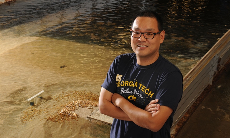 Seung Ho Hong in the Donovan Hydraulics Laboratory with the flume used in his study.