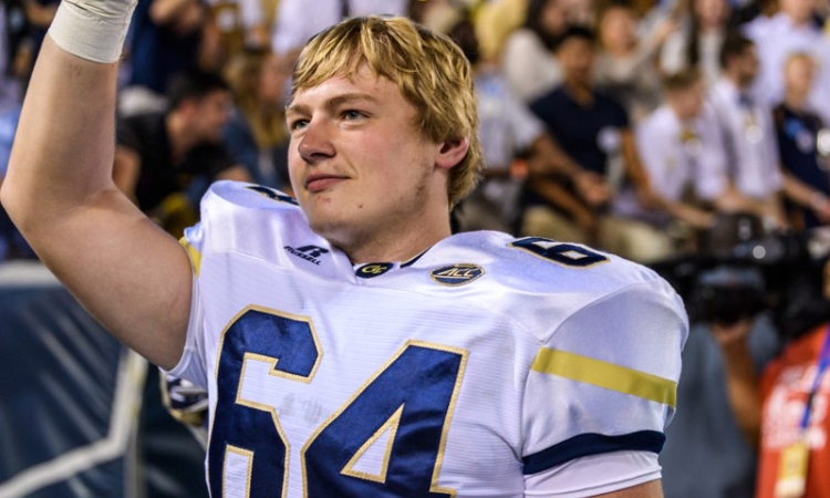 Civil engineering master's student Cheyenne Hunt waves during one of Georgia Tech's football games this year. Hunt is a walk-on offensive tackle finishing his final year on the team. (Photo: Danny Karnik/Georgia Tech Athletics)