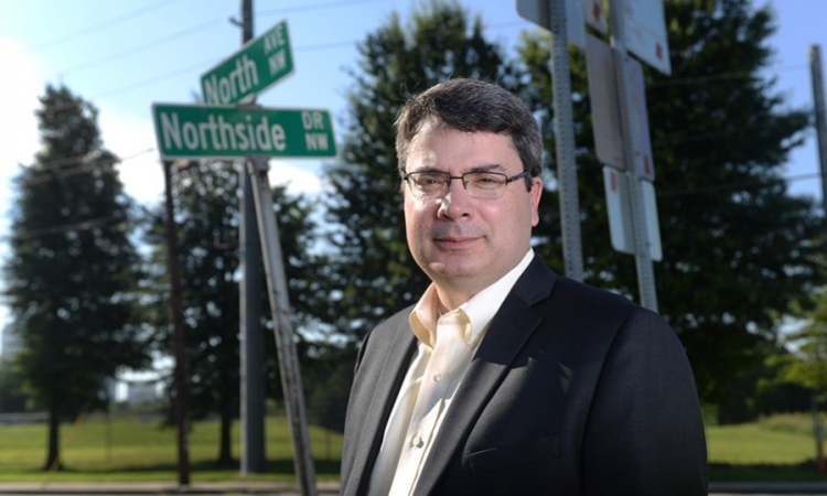 Associate Professor Michael Hunter stands along North Avenue, the City of Atlanta's new "smart corridor." Along with the city, the Georgia Department of Transportation and other partners, Hunter will help cut the ribbon for the corridor Sept. 14. (Photo: Chris Moore) 