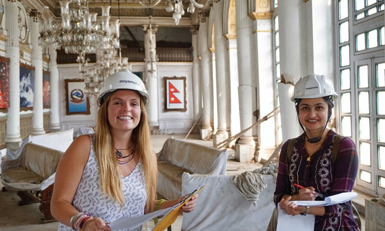 Undergraduate Maggie Lindsey, left, with structural engineer Priyanka Singh in the main room of the Gaddi Baithak in Kathmandu, Nepal. Lindsey was an intern with Miyamoto International in the country during spring 2017, where she worked on a project to restore the 100-year-old palace. (Photo: Binod Shrestha)