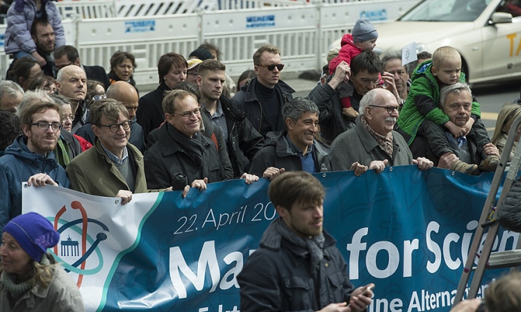 Demonstrators hold a banner reading "March for Science"