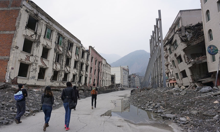 Students from the International Disaster Reconnaissance Studies course walk through ruined buildings in Old Beichuan, China. The city has been left as a memorial to those killed when it was rocked by the 2008 Wenchuan earthquake in central China. The site was one of the places students visited in China and Japan over Spring Break as they considered the impact of disasters and how communities rebuilt. (Photo Courtesy: Lynnae Luettich and Katie Popp)
