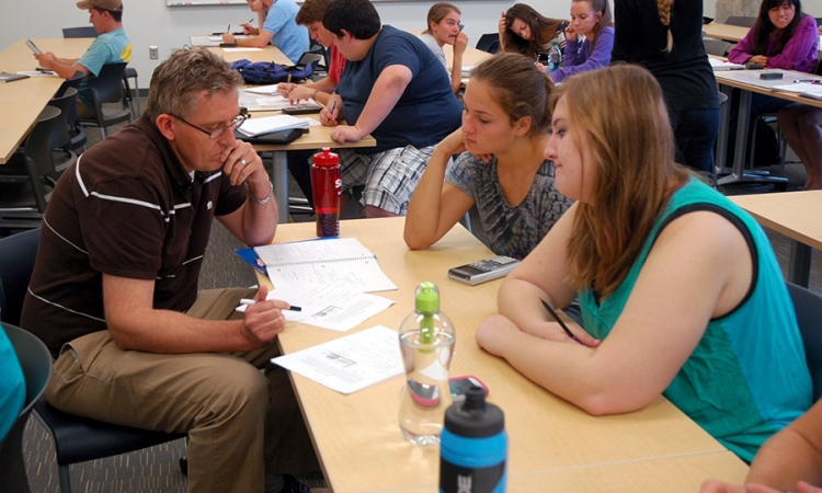 Professor Donald Webster working with students on a problem.