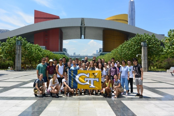 A group holding a flag in front of a building