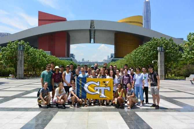 A group holding a flag in front of a building 