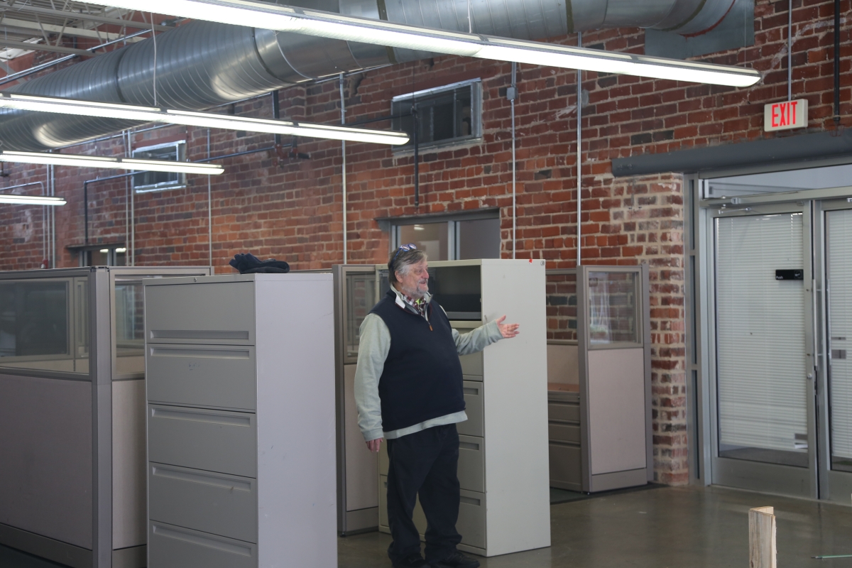 A man stands in an industrial office space