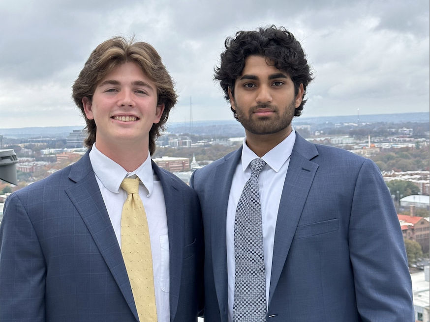 A photo of two young men wearing coats and ties 