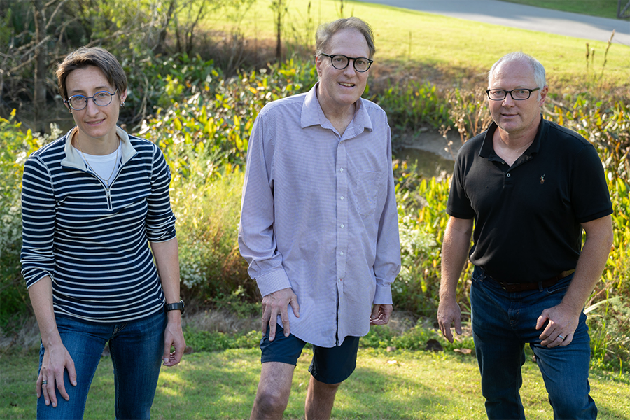 Researchers Chloé Arson, Thomas DiChristina, and Martial Taillefert stand near wetlands on Georgia Tech’s campus