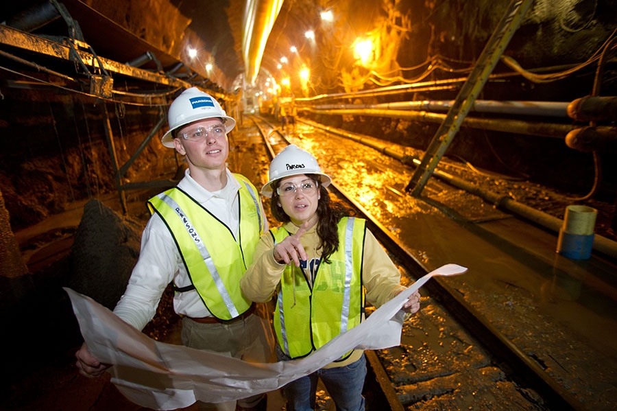 Students examine construction plans in a tunnel. (Photo: Rob Felt)