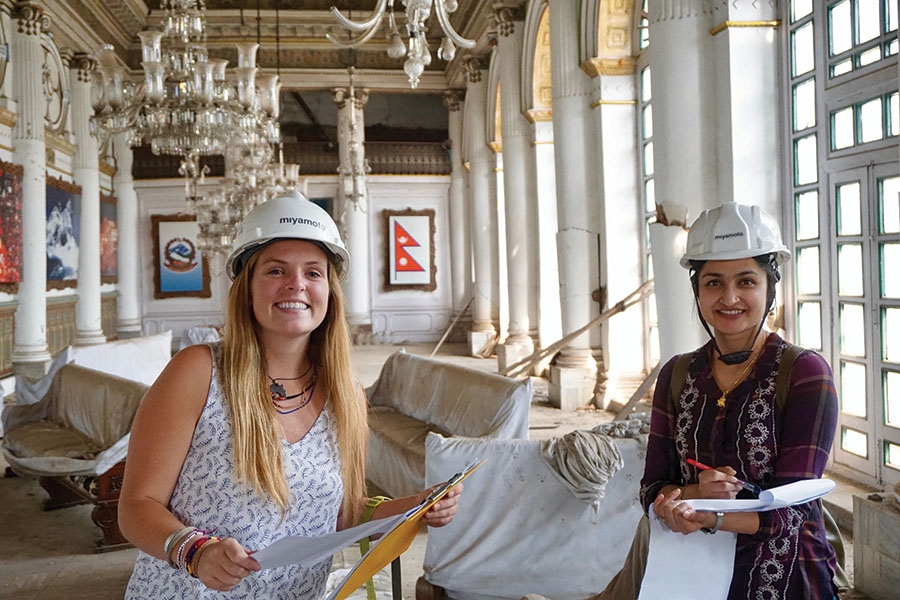 Undergraduate Maggie Lindsey, left, with structural engineer Priyanka Singh in the main room of the Gaddi Baithak in Kathmandu, Nepal. Lindsey was an intern with Miyamoto International in the country during spring 2017, where she worked on a project to restore the 100-year-old palace. (Photo: Binod Shrestha)