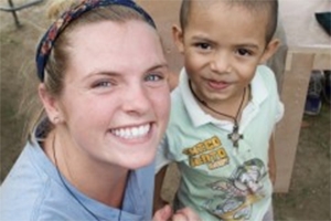 Senior Maggie Lindsey in Costa Rica with one of the young students who will attend a primary school she helped design and build.
