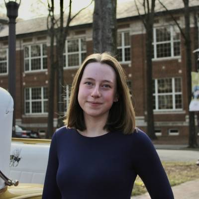 Portrait of Lucy Markovitz in a purple sweater in front of a Georgia Tech building